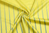 A yellow handball jersey fabric with vertical blue stripes, featuring a logo.