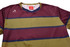 A striped t-shirt featuring maroon, olive green, and navy colours, with a logo on the upper left side.