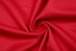 A close-up of red fabric displaying a smooth, swirling texture. The material appears soft and lightweight.