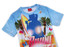 A women's tee shirt with a blue background, featuring a surf theme and palm trees, and a silhouette of a person.