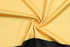 A yellow and black fabric, twisted to showcase its texture and colour, suitable for custom design team t-shirts.