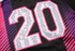 A black and pink top featuring large numbers '20' and a list of names printed in white on the fabric.