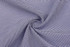A close-up of fabric featuring a blue and white checkered pattern, showcasing its texture and weave.