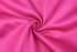 A smooth, vibrant pink fabric, showcasing its texture and sheen in a swirling pattern.