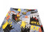 A pair of shorts with a colourful graphic print featuring various designs in blue, yellow, black, and red.