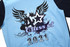 A light blue leavers jacket featuring graphic designs, including stars and wings, with "Class of 2021."
