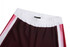 A sports uniform featuring maroon shorts with white and pink stripes along the sides and an elastic waistband.