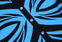 A black shirt featuring a striking blue swirl pattern, with clear buttons down the front.