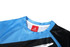 A sports uniform featuring a predominantly blue top with black accents and a logo on the collar.