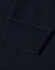 A close-up view of the cuff of a navy blue polo shirt featuring a ribbed design and a logo.