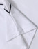 A white short-sleeve polo shirt featuring a textured fabric and contrasting trim. It has a logo on the design.