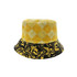 A reversible bucket hat featuring a yellow checkered pattern on one side and a black marbled design on the other.