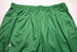 Green athletic shorts with an elastic waistband and side pockets, featuring a brand logo.