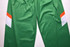 Green sports pants featuring orange and white accents, with a logo on the fabric.