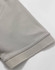 A close-up of a light grey polo shirt sleeve, featuring a solid hem and a smooth fabric texture.