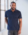 A man models a navy blue short-sleeved polo shirt, featuring a collar and a logo on the chest.