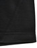 A close-up of a black sustainable poly/cotton polo shirt showing the hem and stitching details. Features a logo.