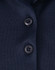 Close-up of a navy blue polo shirt featuring a button placket and a logo.