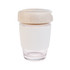 A reusable coffee cup in white with a beige silicone band and a speckled beige lid. It features a branding logo.