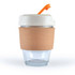 A reusable coffee cup with a cork band and an orange straw. The cup features a clear glass body and a light-colored lid.