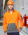 A Hi-Vis orange and grey fleece hoodie with a half-zip and logo, worn by a man in a safety helmet.