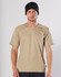 A beige short-sleeve work t-shirt with a textured shoulder design, worn by a model in a black beanie.