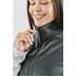 A women's fleece vest in a dark grey colour, featuring a high collar and zip, modelled by a smiling woman.