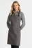 A ladies' long sleeve button-up shirt in grey, featuring a classic collar and paired with a grey apron.