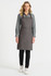 A grey bib apron with leather straps, worn over a grey shirt and black pants, featuring a front pocket.