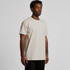A plain beige T-shirt displayed on a model, featuring a round neckline and short sleeves. It has a brand logo.