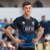 A performance rugby T-shirt in black and blue, featuring a logo and styled with sporty details.