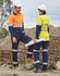 Heavy cotton drill cargo pants in navy blue with 3M reflective tape, worn by two individuals on a construction site.