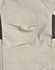 Light grey fabric of work pants featuring detailed stitching and black accents, with a logo present.