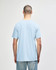A light blue Gildan Softstyle adult t-shirt viewed from the back, featuring a simple design and a branding logo.