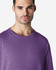A man wearing a purple Gildan Softstyle adult T-shirt, featuring a round neckline and short sleeves.