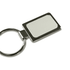 A rectangular silver keychain with a smooth surface and a metal ring attachment.