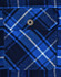A close-up of a blue and white quilted flannel shirt featuring a pocket with a snap button. It has a plaid pattern.