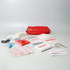 A red first aid kit containing bandages, gauze, antiseptic wipes, scissors, and a first aid manual.