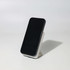 A black wireless charging power bank stands on a white base, showcasing its sleek design.