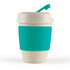 A reusable coffee cup in a creamy color with a teal silicone band and lid. It features a small drinking spout.