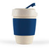 A reusable coffee cup in a cream color with a navy silicone band and a blue lid featuring a flap.