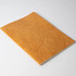 A notebook with a textured orange cover, featuring a simple design without visible branding.