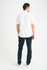 A man wearing a white short sleeve button-up shirt, standing with his back to the camera, paired with dark jeans.