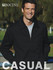 A man wearing a black unisex adults canvas jacket stands outdoors, smiling. The jacket features a brand logo.
