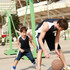 A pair of kids basketball shorts in navy blue with white accents, featuring a logo, suitable for sports activities.