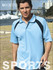 A light blue unisex polo shirt with navy accents and a logo, displayed on a model outdoors by a bridge.