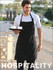 A man wearing a black cotton drill full bib apron with a pocket, holding a tray with two cups.