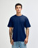 A navy unisex short sleeve T-shirt displayed on a model with tattoos, featuring a simple design and no visible branding.