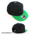 A black cap with an emerald green brim and button, featuring a branding logo.