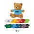 A fluffy brown teddy bear wearing a blue shirt with a logo, surrounded by various colourful t-shirts in different sizes.